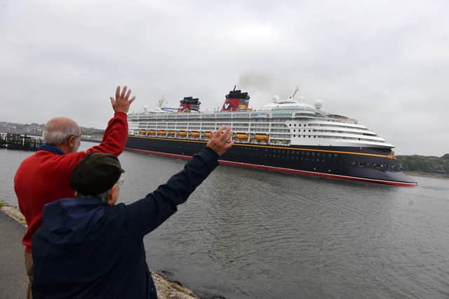 Spectators wave as Disney Magic arrives at the River Tyne in July 2017.