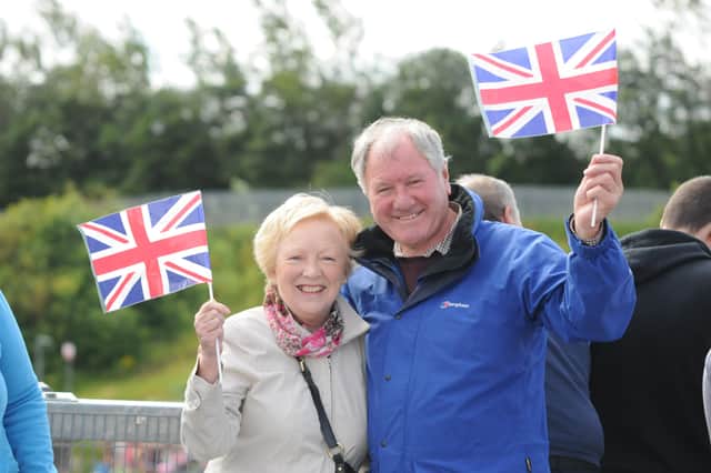 Retired couple Bill and Dorothy Marley wave their flags during the Queen's visit in 2012.