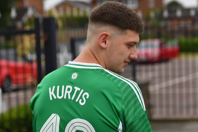 A mourner wearing a green football shirt in tribute to Kurtis Stubbings.