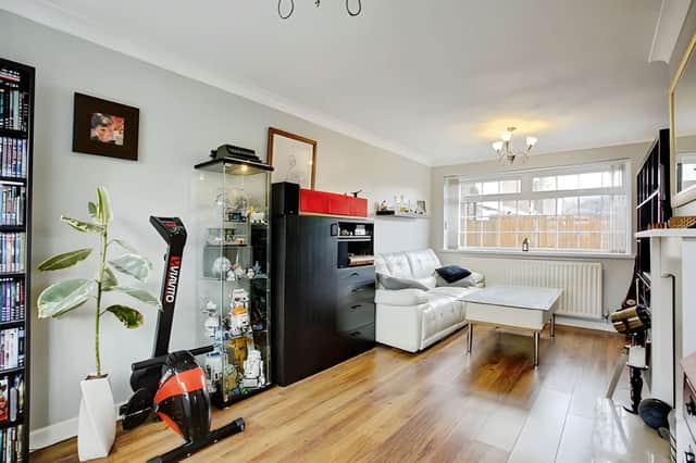 The bright living room offers a comfortable setting for everyday life, creating a welcoming space to unwind or entertain.