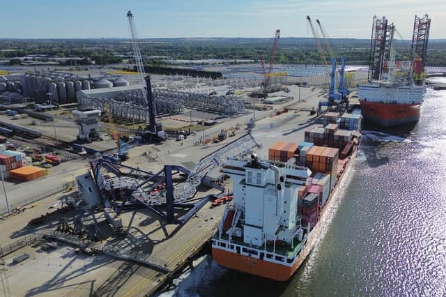 Another view of the mangled wreck of the crane leaning against a container ship in the Port of Tyne.