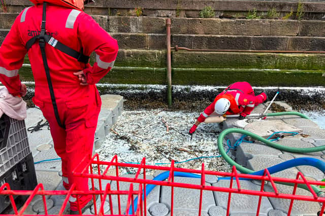 Workers on floating pontoon platforms scoop up nurdles from the riverside at Low dock, North Shields 2.jpeg