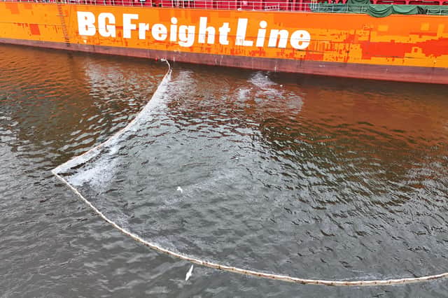 A boom was deployed around the container ship