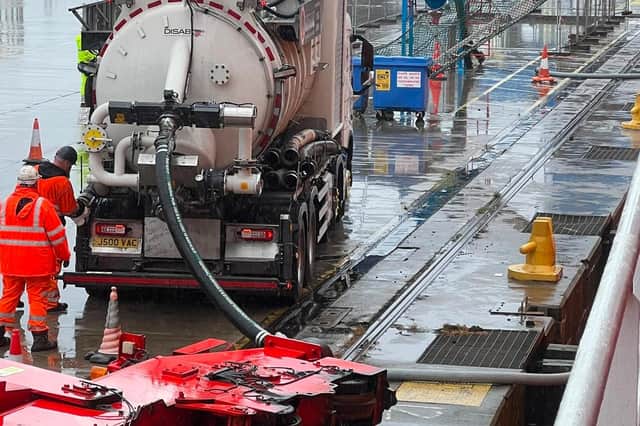 The pellets are being removed from containers and put into land vehicles at the Port of Tyne.