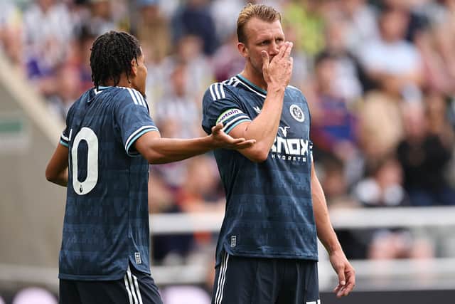 Will Osula (l) and captain Dan Burn of Newcastle United in discussion during the pre-season friendly match between Newcastle United and Strasbourg at St James' Park on August 16, 2026 in Newcastle upon Tyne, England. (Photo by Stu Forster/Getty Images)