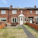The John Reid Road mid-terraced home has an attractive front garden with a seating area and three bedrooms inside