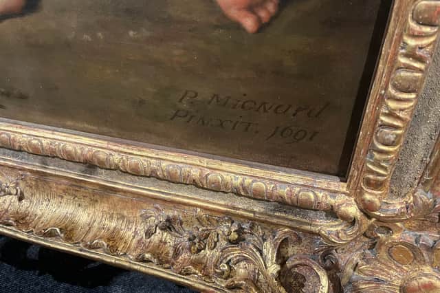 The artist's signature on the work.