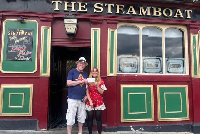 Alan Cowell of South Shields Masonic Hall hands over a cheque to event organiser Helen Rodgers at The Steamboat.