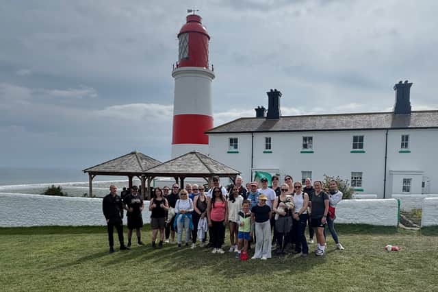 Charity walkers take at rest at Souter Lighthouse, the walk's halfway point.