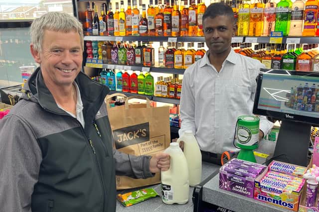 Yogendran Mutthulingam serves shopper Dave Green at the new Jarrow Premier.