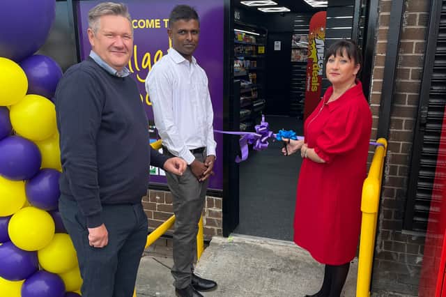 Cllr Geraldine Kilgour gets ready to cut the ribbon with shop owner owner Yogendran Mutthulingam (centre) and John Carter, Booker retail development manager.