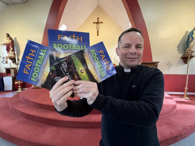 Father Marc Lyden-Smith with his new book, Faith and Football.