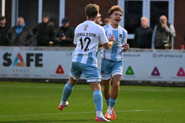 Kian Freeman celebrates with Hebburn Town team-mate Josh Donaldson after scoring in their defeat at Radcliffe (photo Tyler Lopes)