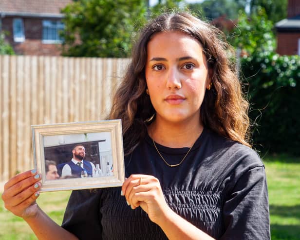 Anissa Khalfa, from Jarrow, holding a photo of her cousin Tom, who passed away after struggling with alcohol addiction and mental health issues.