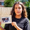 Anissa Khalfa, from Jarrow, holding a photo of her cousin Tom, who passed away after struggling with alcohol addiction and mental health issues.