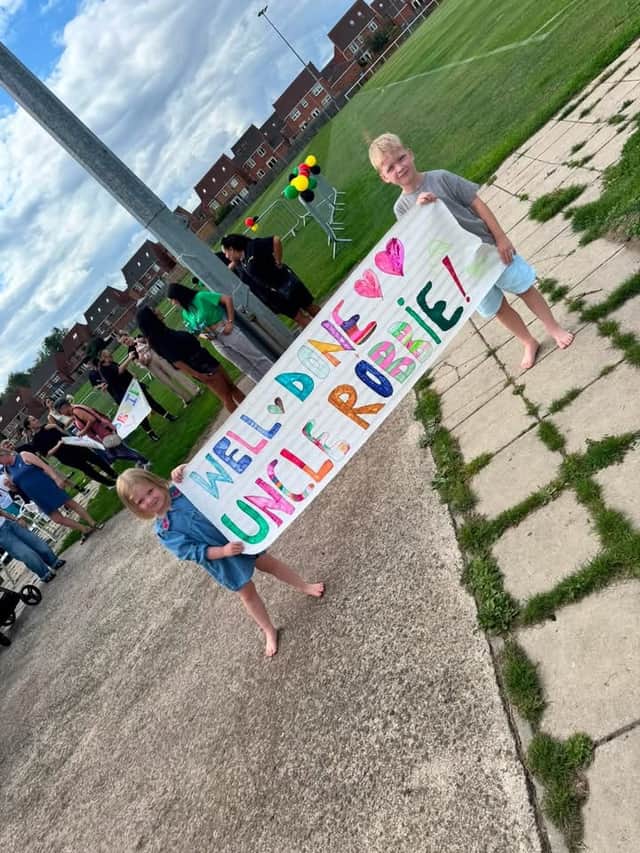 Robbie Gray’s niece and nephew, Jorgie Routledge, four, and Freddie Routledge, eight, with their banner