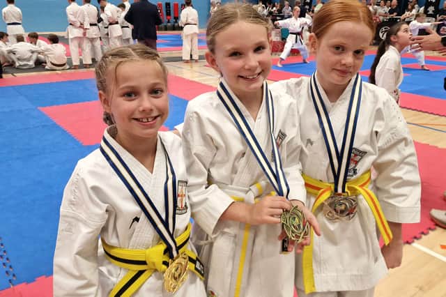 Dokan Karate Club students Holly, Daisy and Hollie with their medals from the Great British Open Championships.