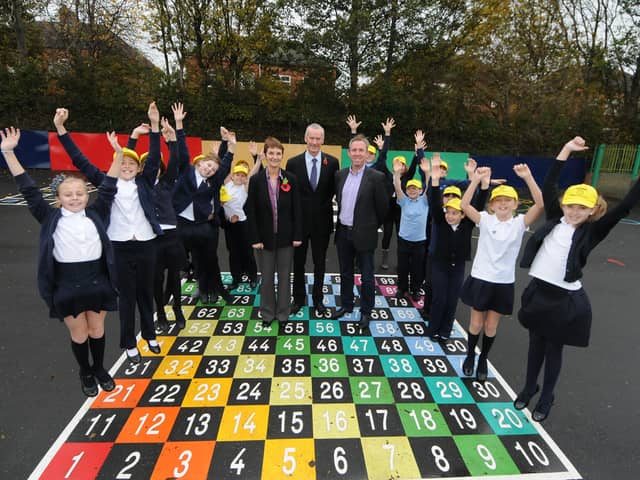 These colourful new playground markings were on show at Mortimer Primary School in November 2011. 
The photo shows some of the school pupils with deputy head teacher Pam Appleby, head Geoff Seagrove and business man Graeme Foreman.