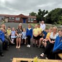 Staff, pupils, and Ed Malcolm, chair of governors, celebrate Lord Blyton Primary School’s positive Ofsted report.