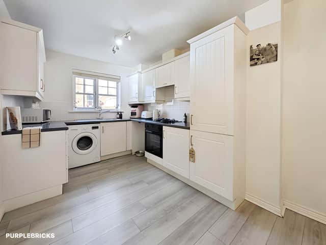 The dining kitchen occupies the ground floor, providing a practical space for preparing meals and enjoying everyday family life.