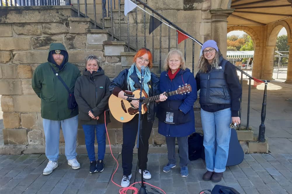 Singer Erin Roche, market manager Beth Durkin (right), and traders Dan Jameson, Helen Stewart, and Pauline Smith.
