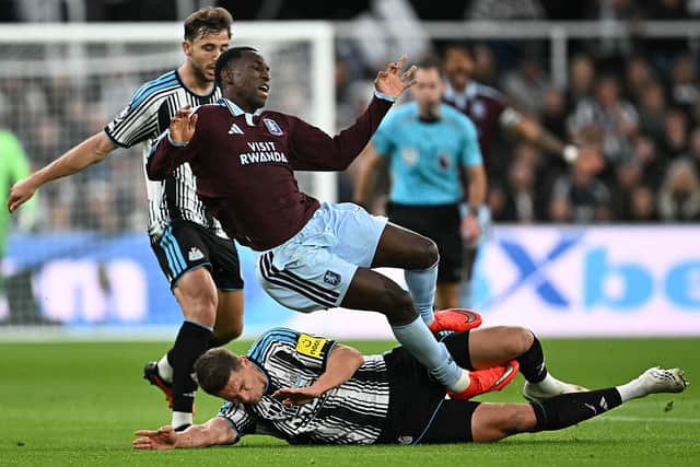 Newcastle United's Dutch defender #04 Sven Botman (down) fouls Aston Villa's Senegalese striker #11 Nicolas Jackson (up) during the English Premier League football match between Newcastle United and Aston Villa at St James' Park in Newcastle-upon-Tyne, north east England on October 17, 2026. (Photo by Paul ELLIS / AFP via Getty Images)