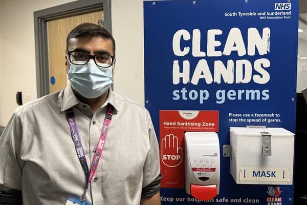 Dr Shaz Wahid at a hospital hygiene station.