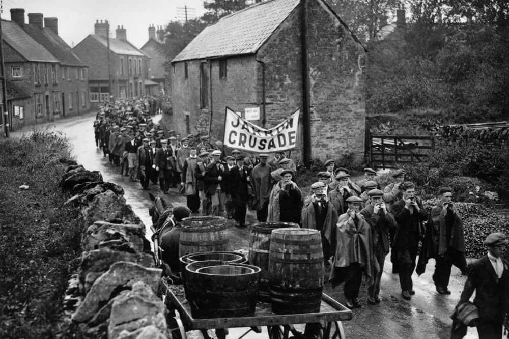 Jarrow marchers passing throught the village of Lavendon, near Bedford, on their way to London, many playing mouth organs to keep spirits up. 
(Photo by Savill/Getty Images)