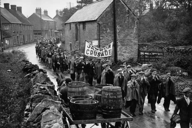 Jarrow marchers passing throught the village of Lavendon, near Bedford, on their way to London, many playing mouth organs to keep spirits up.
(Photo by Savill/Getty Images)