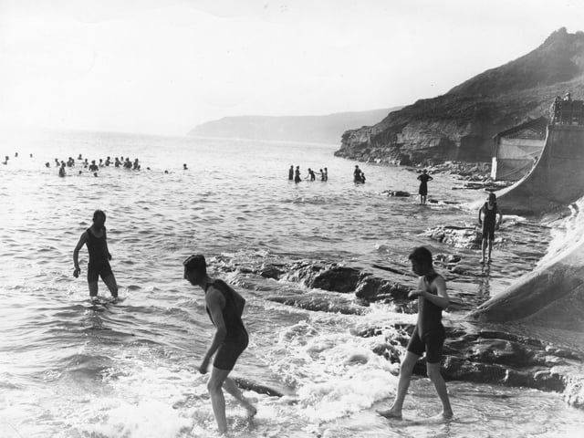 circa 1911: Eager bathers go for an early morning dip at Scarborough, Yorkshire.