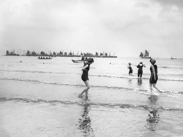 circa 1911: A group of female bathers go for an early morning dip in the sea at Scarborough, Yorkshire.