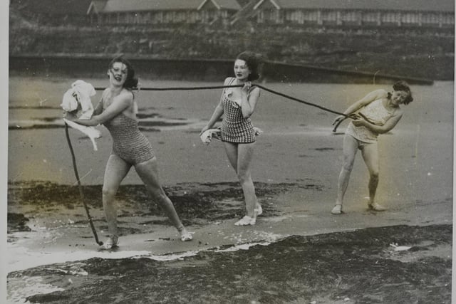 December 1938. In spite of the temperature being below freezing point, these hardy girls at Scarborough donned bathing costumes and ran down to the sea, but there their courage failed for they only went knee-deep into the water.