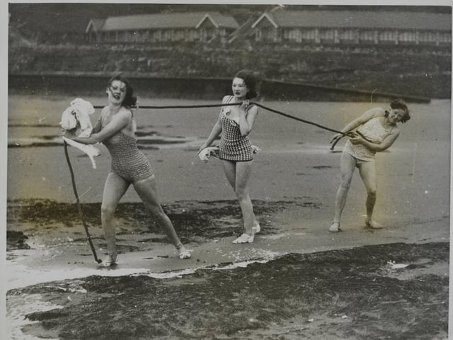 December 1938. In spite of the temperature being below freezing point, these hardy girls at Scarborough donned bathing costumes and ran down to the sea, but there their courage failed for they only went knee-deep into the water.