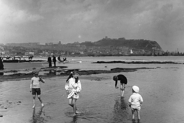 circa 1913: Children on the sands at Scarborough.