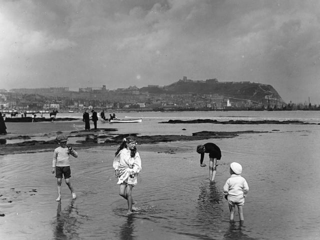 circa 1913: Children on the sands at Scarborough.