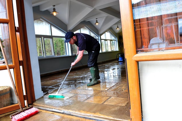 Staff cleaning out the Marigold cafe in 2020 after it filled with floodwater from the River Nidd.
