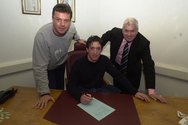 Robbie Fowler is pictured with manager David O'Leary and chairman Peter Ridsdale signing his Leeds United contract.