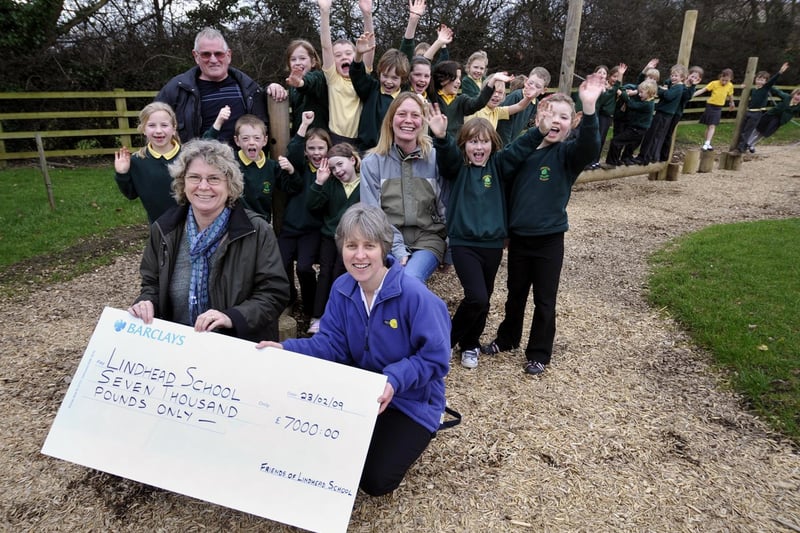 Pam Gaskell, front left, assistant head of Lindhead Primary School, receives 
a cheque for £7,000 to pay for the new adventure play area.