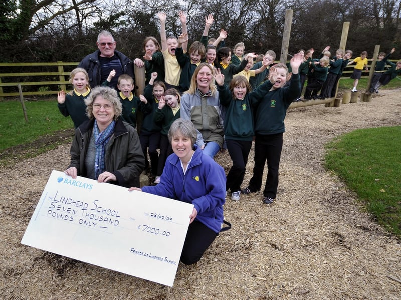 Pam Gaskell, front left, assistant head of Lindhead Primary School, receives
a cheque for £7,000 to pay for the new adventure play area.