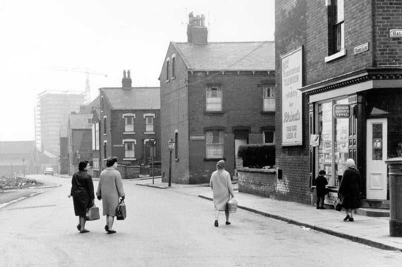 May 1966 and in view is Green Lane, showing the junctions with (from right) Hall Lane, Hawthorn Grove, Hawthorn Avenue, First Avenue and Second Avenue. A corner shop on the right displaying an advert for Rhinds Radio and Television dealers of Tong Road on the wall.