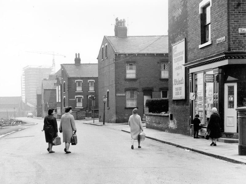 May 1966 and in view is Green Lane, showing the junctions with (from right) Hall Lane, Hawthorn Grove, Hawthorn Avenue, First Avenue and Second Avenue. A corner shop on the right displaying an advert for Rhinds Radio and Television dealers of Tong Road on the wall.