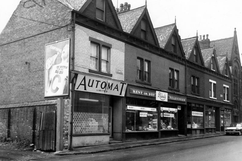 Amberley Buildings on Tong Road in May 1965. Businesses include Automat Ltd, Rhinds, television contractors and dealers as well as a hairdressers, owned by Albert H. Meechan.