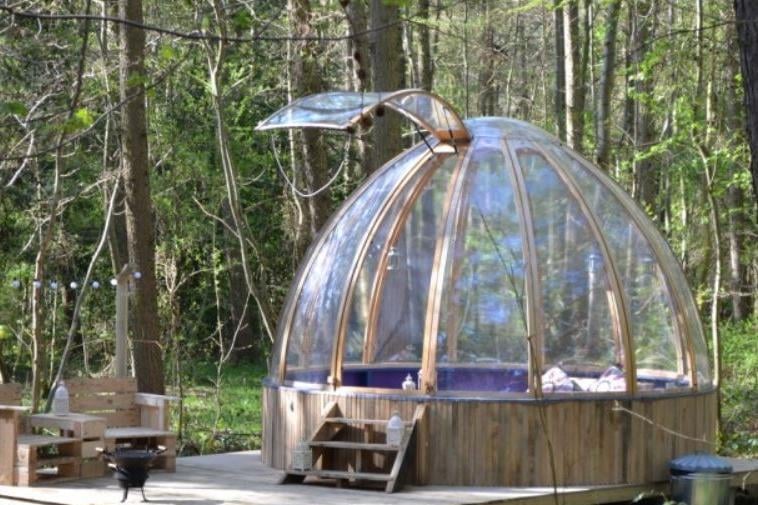 Camp Katur is a beautiful glamping village in a 250-acre estate near Bedale, North Yorkshire. It offers a range of glamping pods, from bell tents which sleep five to cosy 'Romeo & Juliet' pods for two. Pictured is the Woodland Hide, a clear dome offering panoramic views of the surrounding woods.