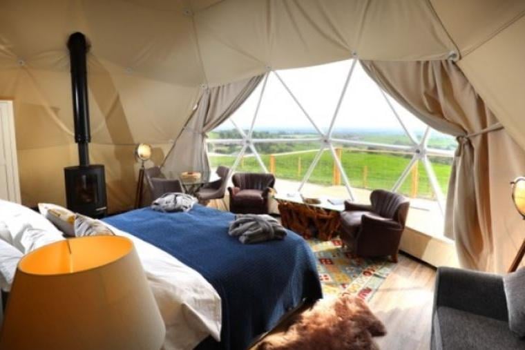 Experience farm-fresh living and incredible views from a luxury geodesic dome in the North Yorkshire Wolds. Each dome sleeps up to two adults and two children and features a fully-equipped kitchenette, wood-burning stove, a downy superking or twin beds, and an ensuite bathroom with flushing toilet.