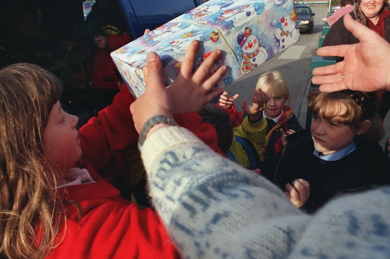 A helping hand from a pupil at Park Spring Primary loading shoeboxes at Safeways in LS13 for the YEP toy appeal for Romania.