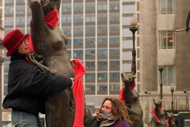Members of the Leeds-based Women's Environmental Network protected the City Square nymphs with red scarves on International Women's Day.
