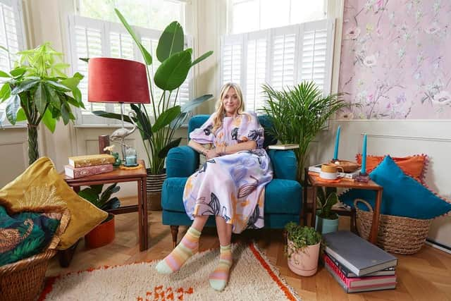 A relaxing reading den furnished with candles and colourful soft furnishings