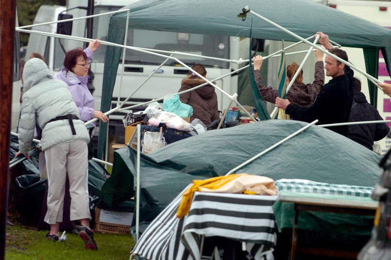 Residents and helpers struggling with the conditions as rain tries to spoil Seacroft Gala in July 2008.