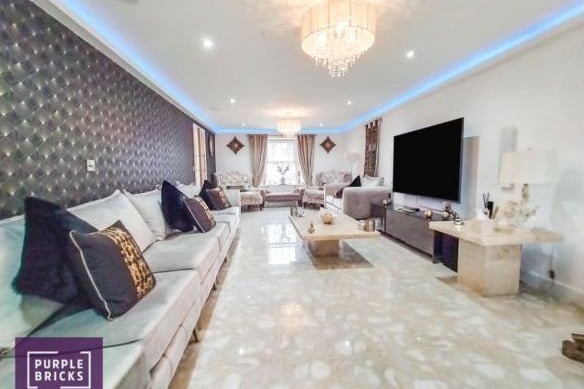 The lounge is light and luxurious, with white marble flooring, velvet sofas and a chandelier fitting.