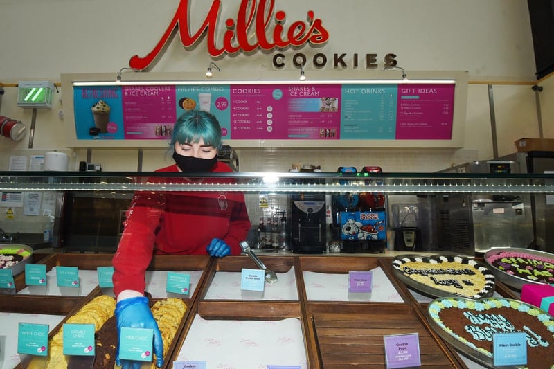 Chloe Woodcock from Millies Cookies is happy to be back at work and serving customers at The Grand Arcade shopping centre, Wigan.